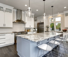 Beautiful Kitchen In Luxury Home Interior With Island And Stainless Steel Chairs