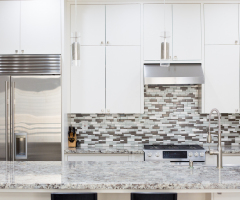 Snapshot of interior modern kitchen with granite countertop island and smart refrigerator