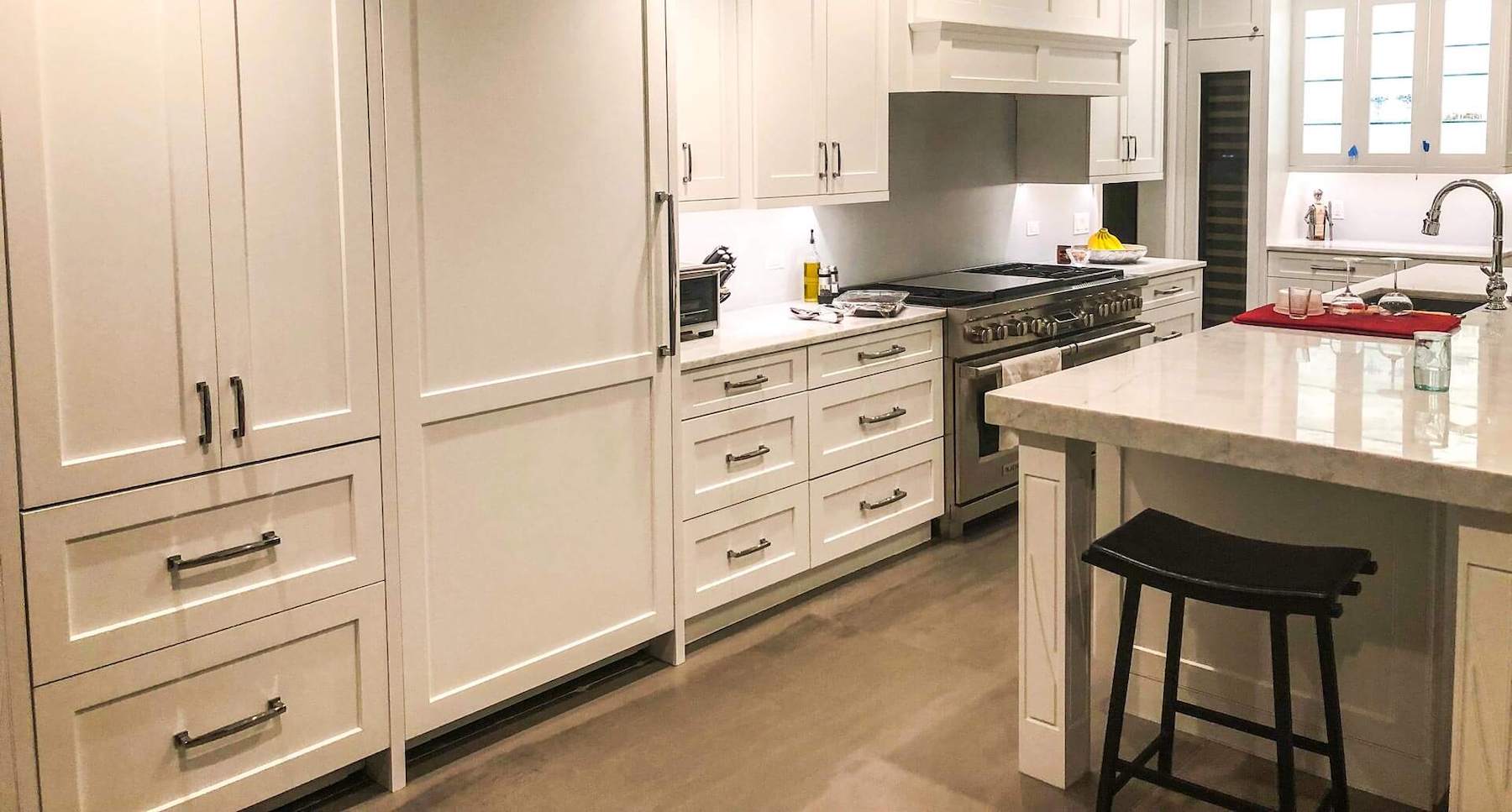 A white, newly-renovated kitchen with a kitchen pantry.