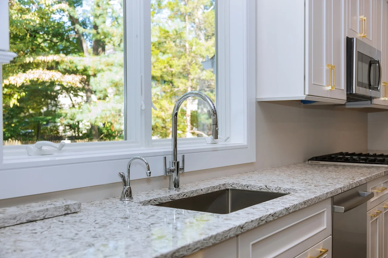 Kitchen sink under window with natural light in Michigan home